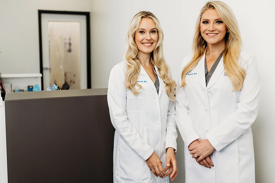 Two Female Board-Certified Facial Plastic Surgeons Standing In Their Office