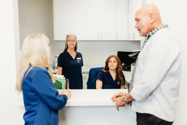 male vs female pattern baldness: bald male standing in FSIBR reception