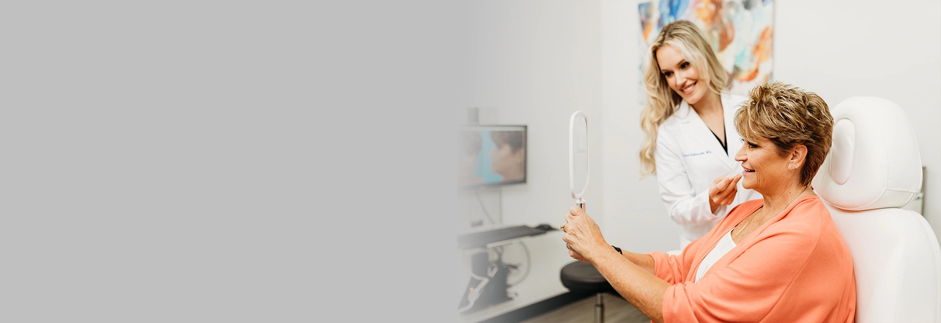 dr-klimczak-with-female-patient-looking-in-the-mirror-at-jowls-treatment-results