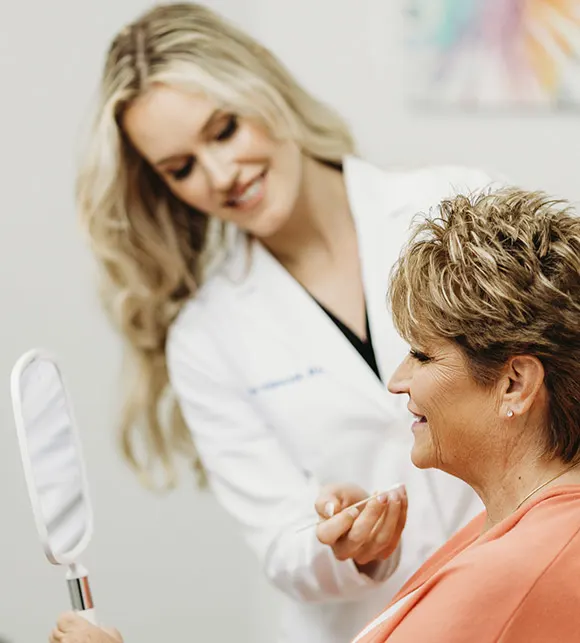 Drooping eyebrows: Surgeon consulting older female patient evaluating brow position