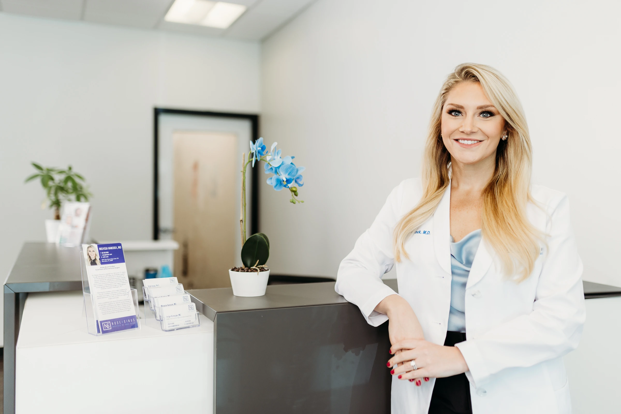 Upper face surgery: Two female surgeons smiling in clinic reception area